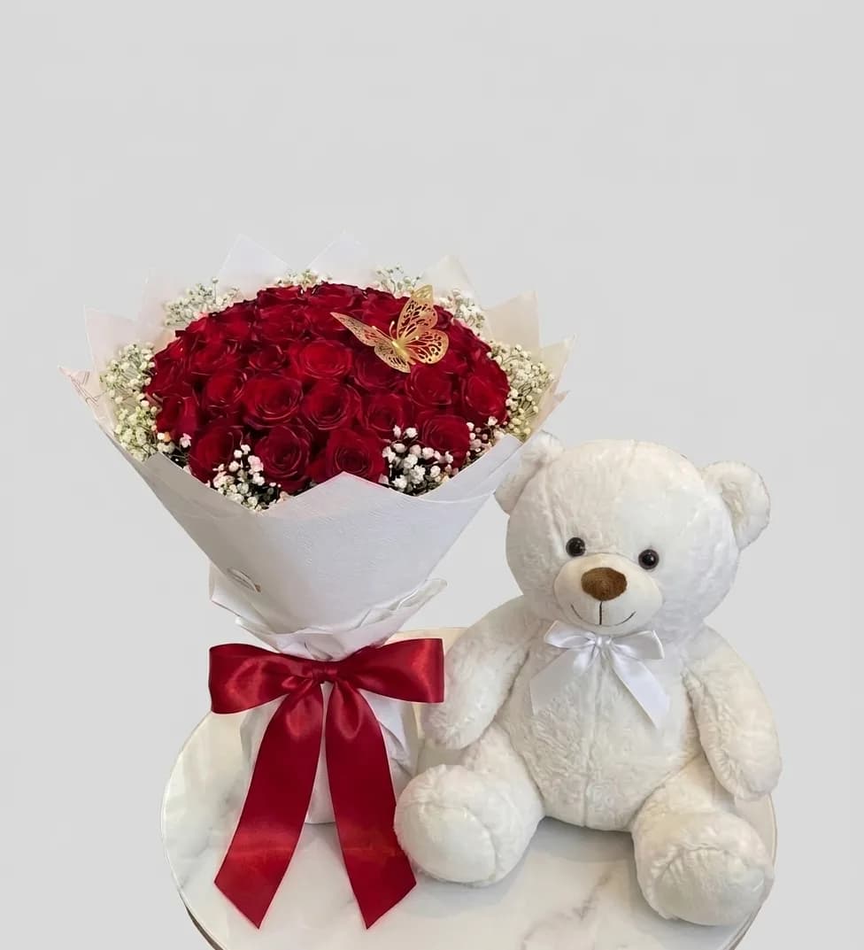Luxury bouquet of 31 red roses with a teddy bear image